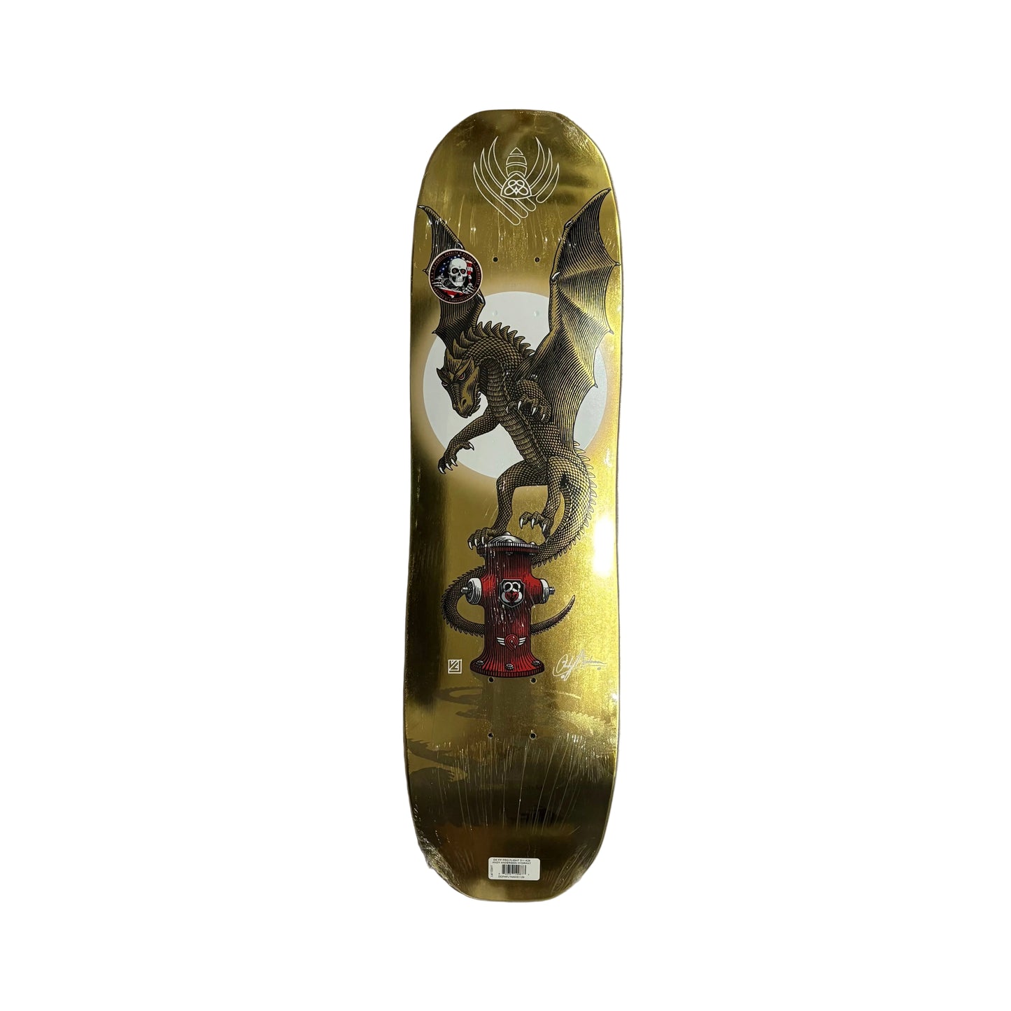 gold foil skateboard deck with dragon graphic on white background