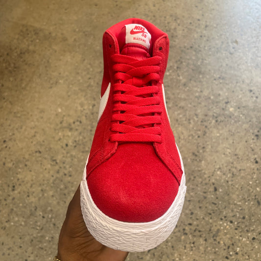 top down view of red suede sneaker with red laces, white sole