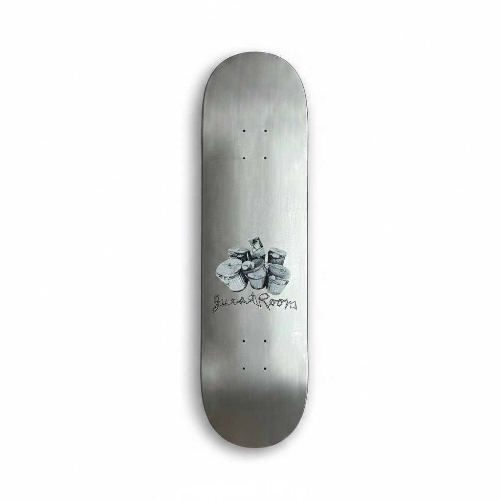 silver skateboard deck with trash can and guest room logo printed towards the bottom of deck, on a white background
