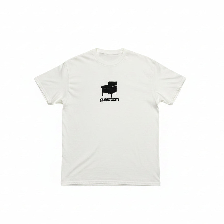white t-shirt with chair and GUESTROOM printed on center chest of the t-shirt, on a white background