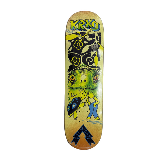 Multi colored krooked skateboard deck with mark gonzales artwork of man a turtle, as well as green and yellow patterns, on a white background