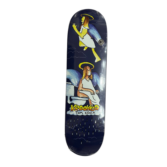 A skateboard deck featuring a dark blue background with two illustrated angels, one standing and one sitting on a toilet, with the text 'KROOKED TOM KNOX' near the bottom.