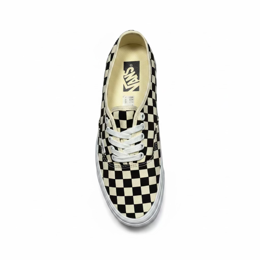 overhead view of black and white checkerboard deck shoe from vans, against white background
