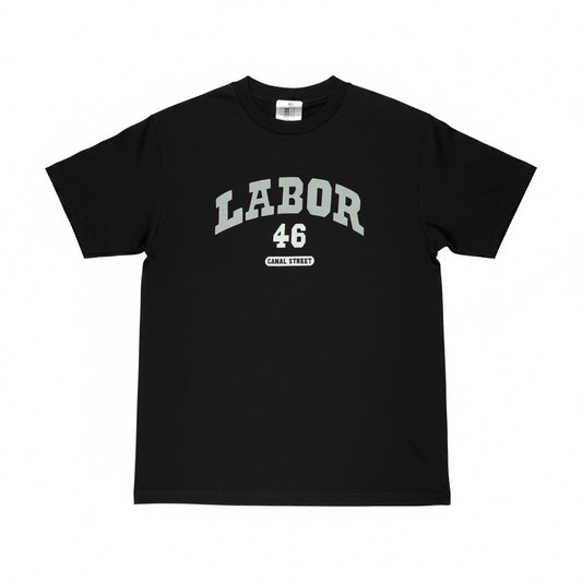 A black short-sleeve t-shirt laid flat on a white surface, featuring a light gray graphic print on the chest that reads 'LABOR 46' with 'CANAL STREET' underneath.