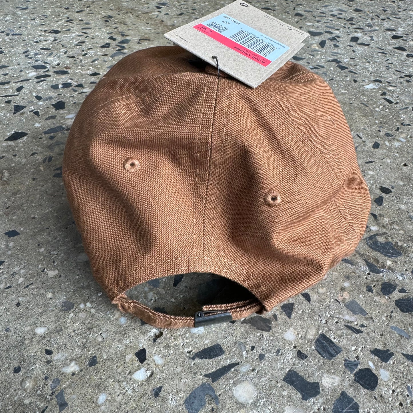 photo of the back of the cap. twill strap with metal buckle