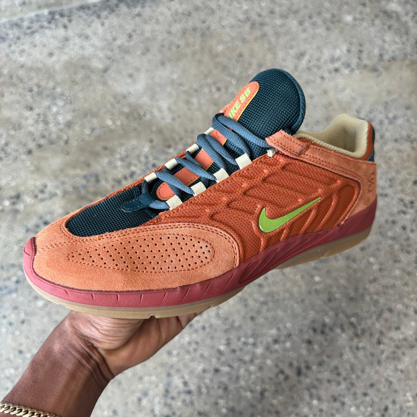 rust colored shoe with pea green nike logo and gum sole