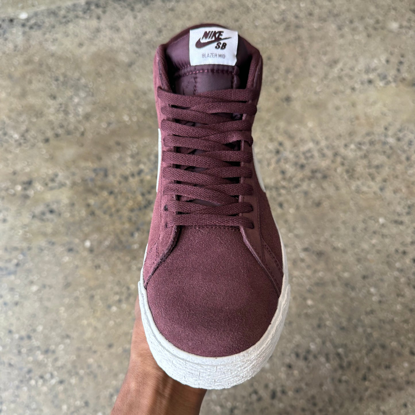 front view of the shoe. burgundy shoe with white tag on the tongue