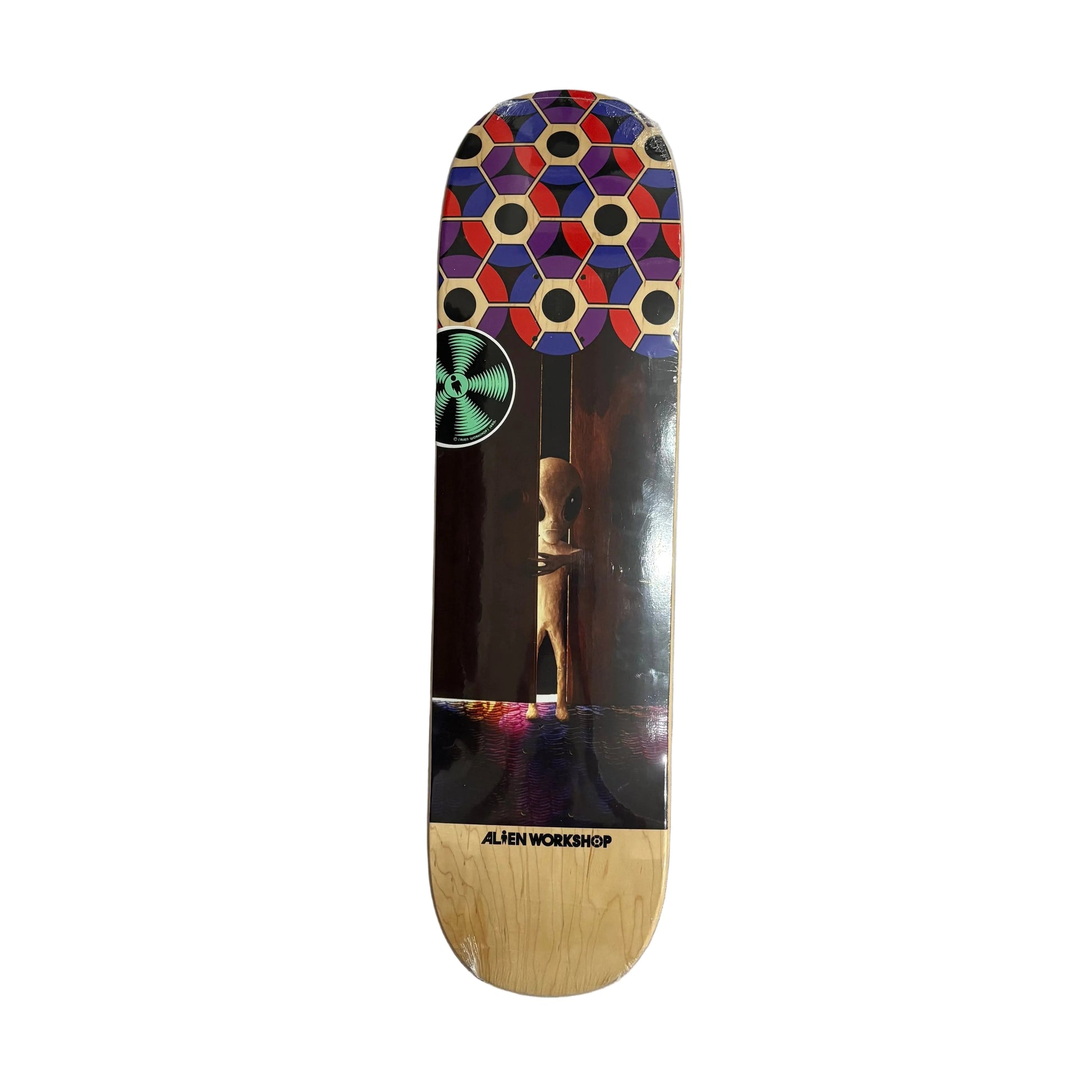 skateboard deck with photo of alien peaking out of the crack in a partially open door with a pattern on the nose of board