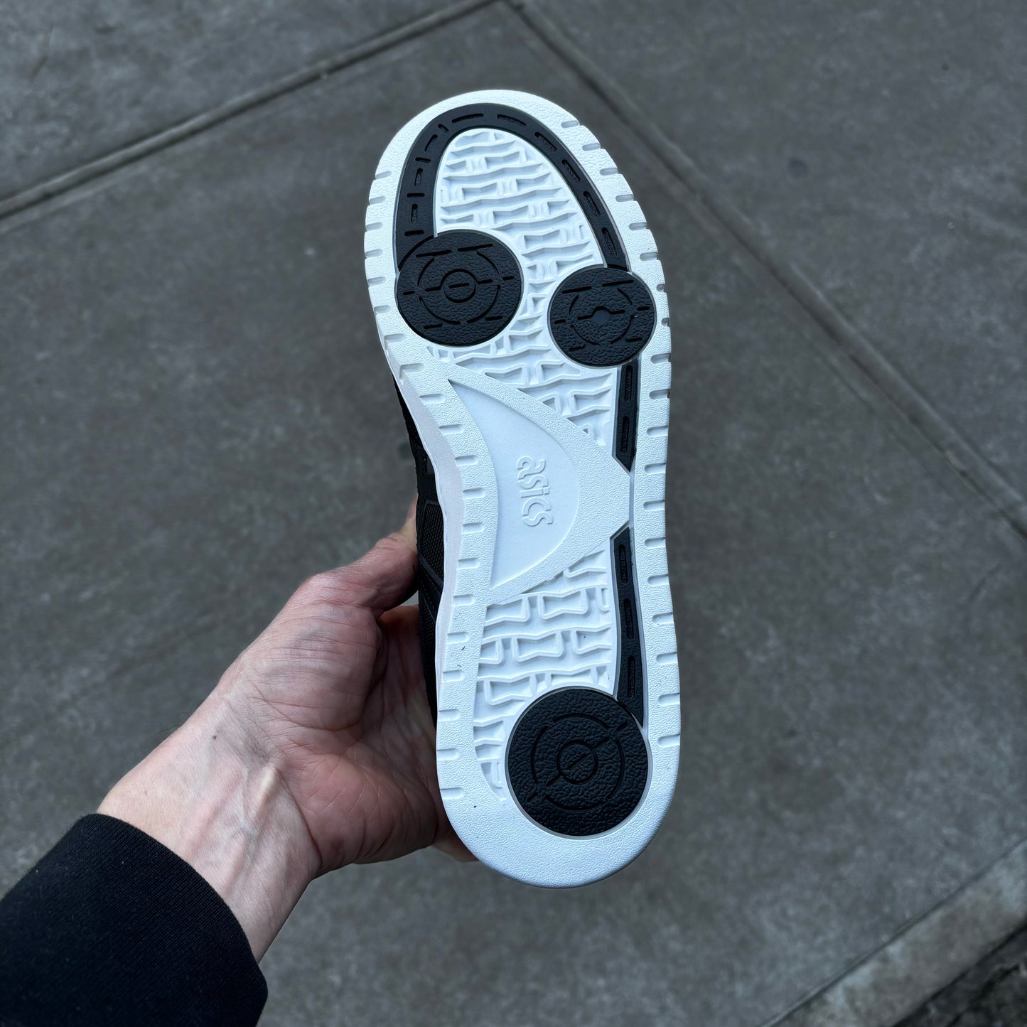 view of white and black rubber outsole on skateboard sneaker