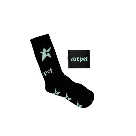 A black crew sock with light blue star and gothic lettering, displayed next to its black packaging box on a white background.