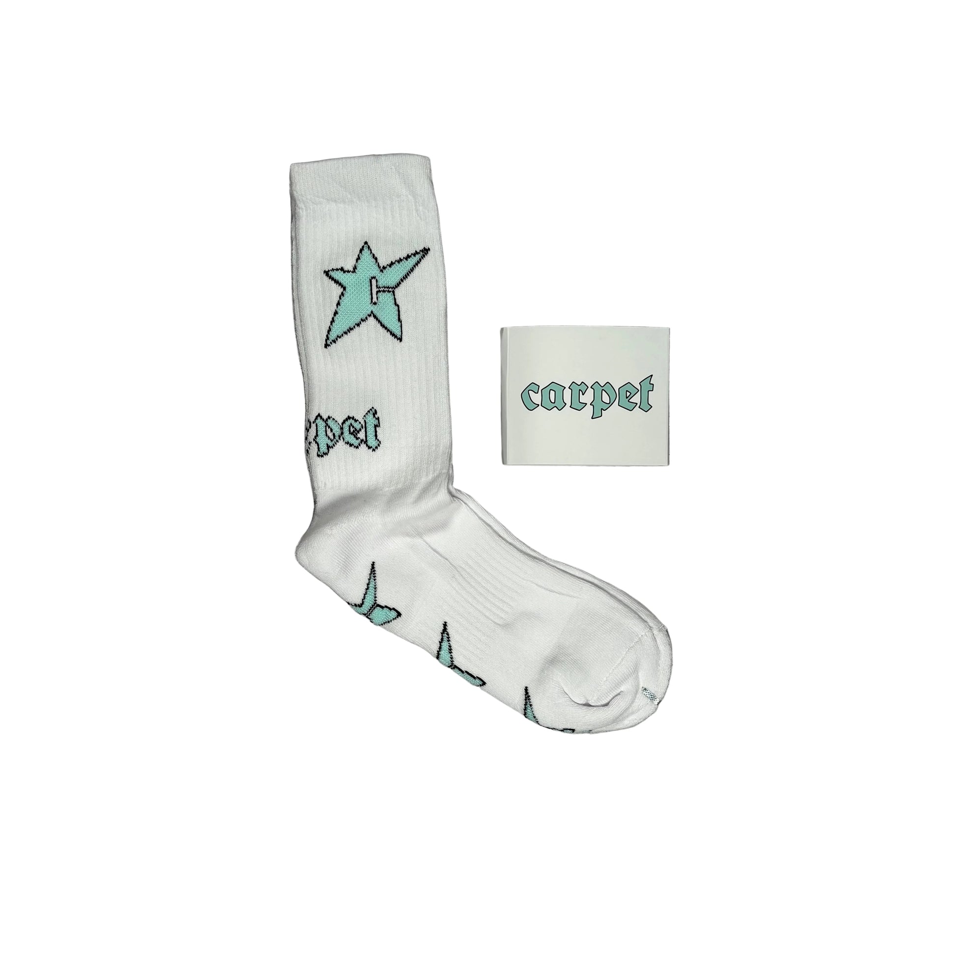 A single white crew sock with a light blue star and gothic-style 'carpet' text, displayed next to a small white square packaging card with the same branding on white background.