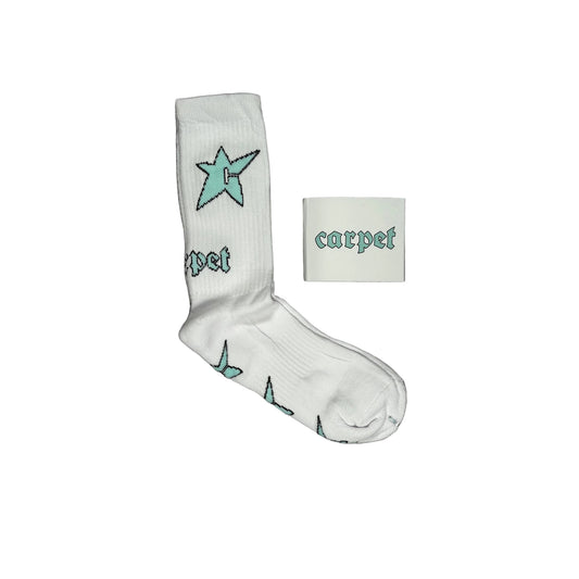 A single white crew sock with a light blue star and gothic-style 'carpet' text, displayed next to a small white square packaging card with the same branding on white background.