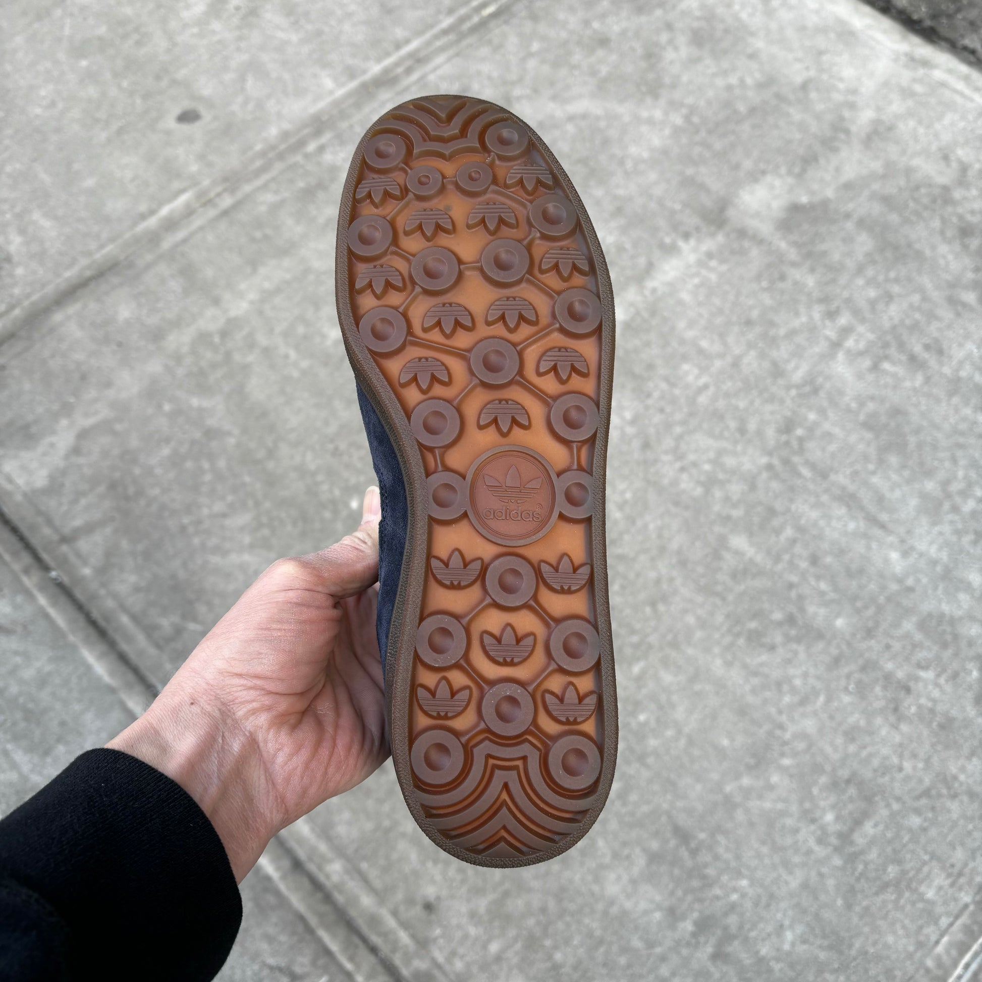 view of gum rubber outsole on navy suede skateboard sneaker