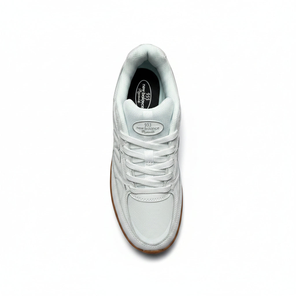 A single white leather sneaker with white laces and a brown gum sole, photographed from a top-down perspective on a white background
