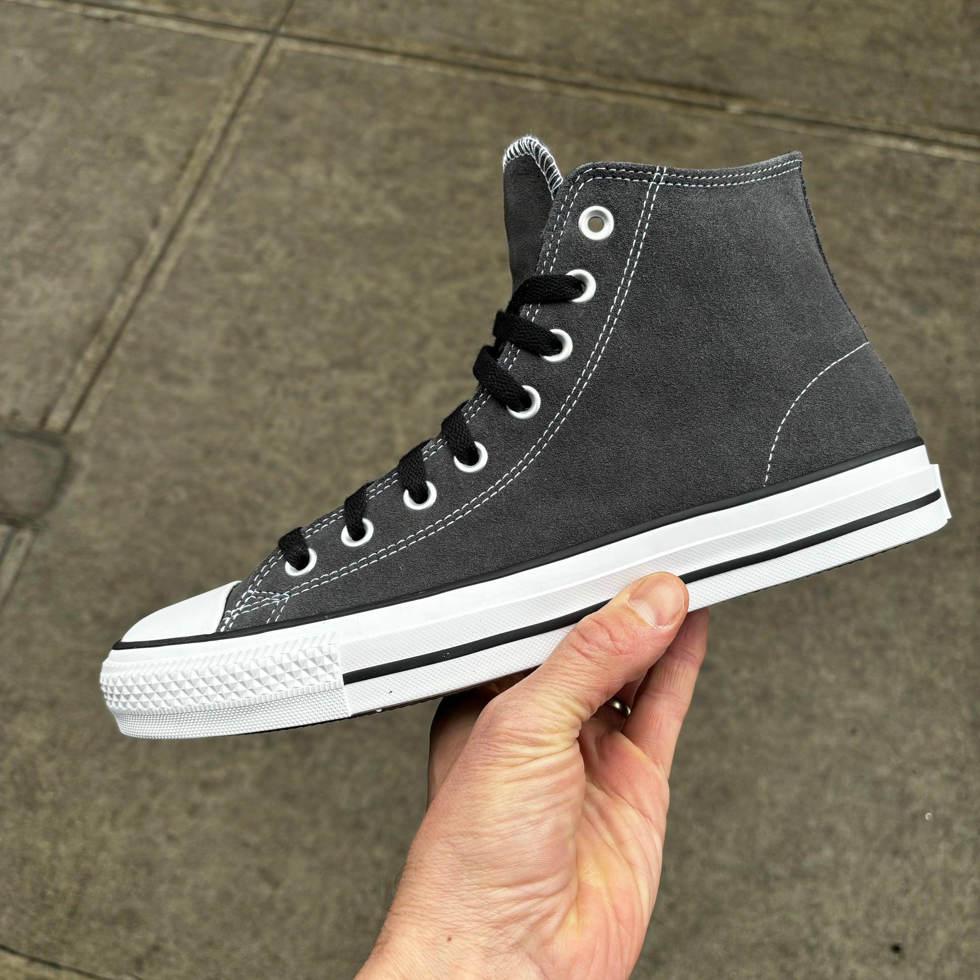 Side view of grey suede mid top skateboard sneaker