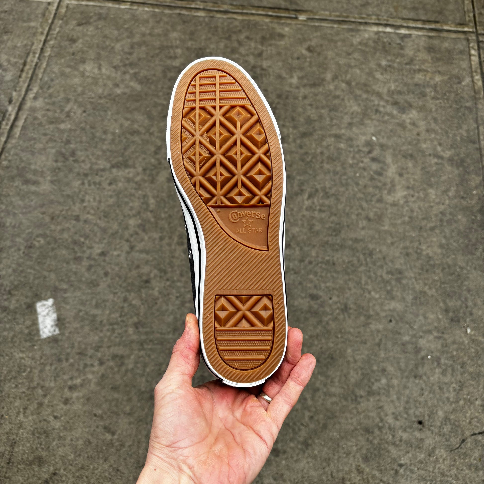 view of gum rubber outsole on suede skateboard sneaker