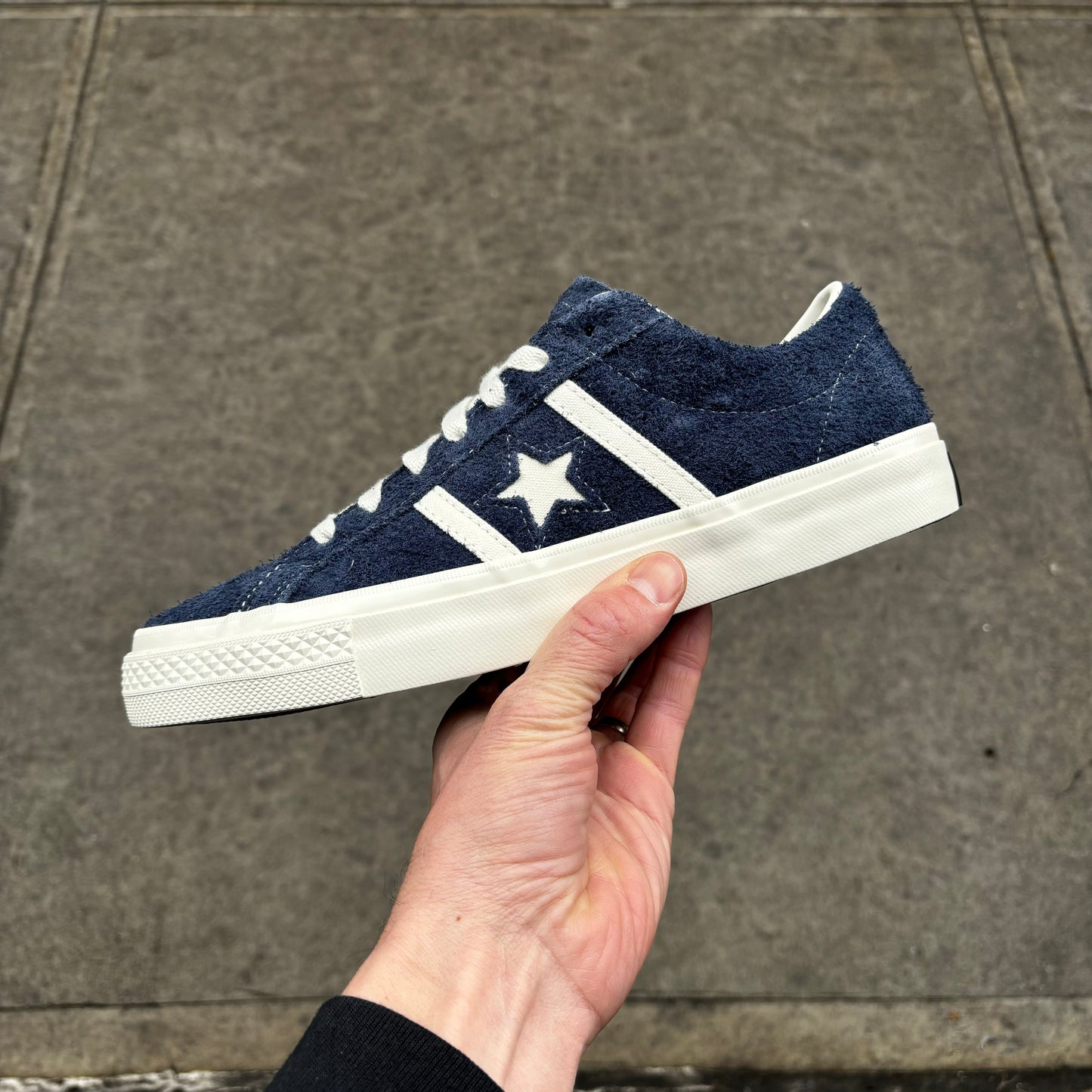 side view of navy blue suede low top skateboard sneaker