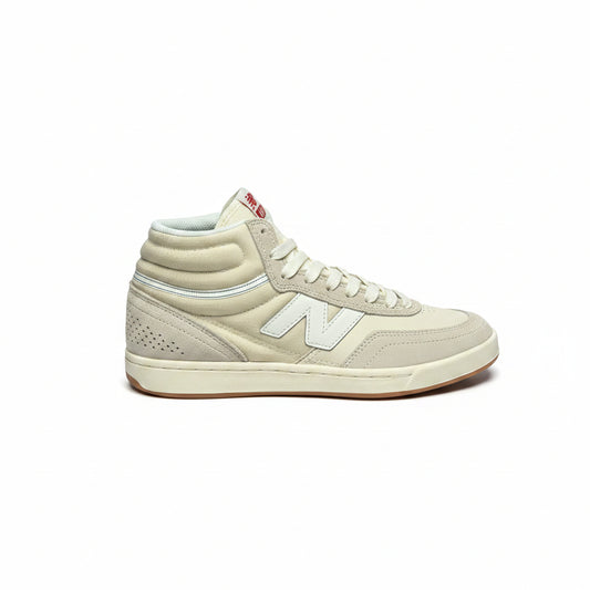 A single New Balance mid-top sneaker in a light cream/off-white colorway, shown from the side against a white background.