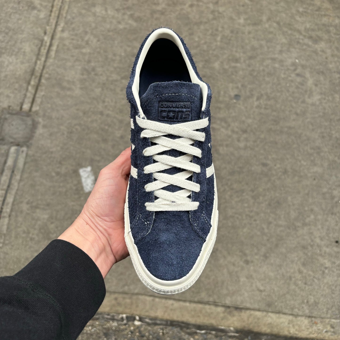 Top down view of navy blue suede skateboard sneaker