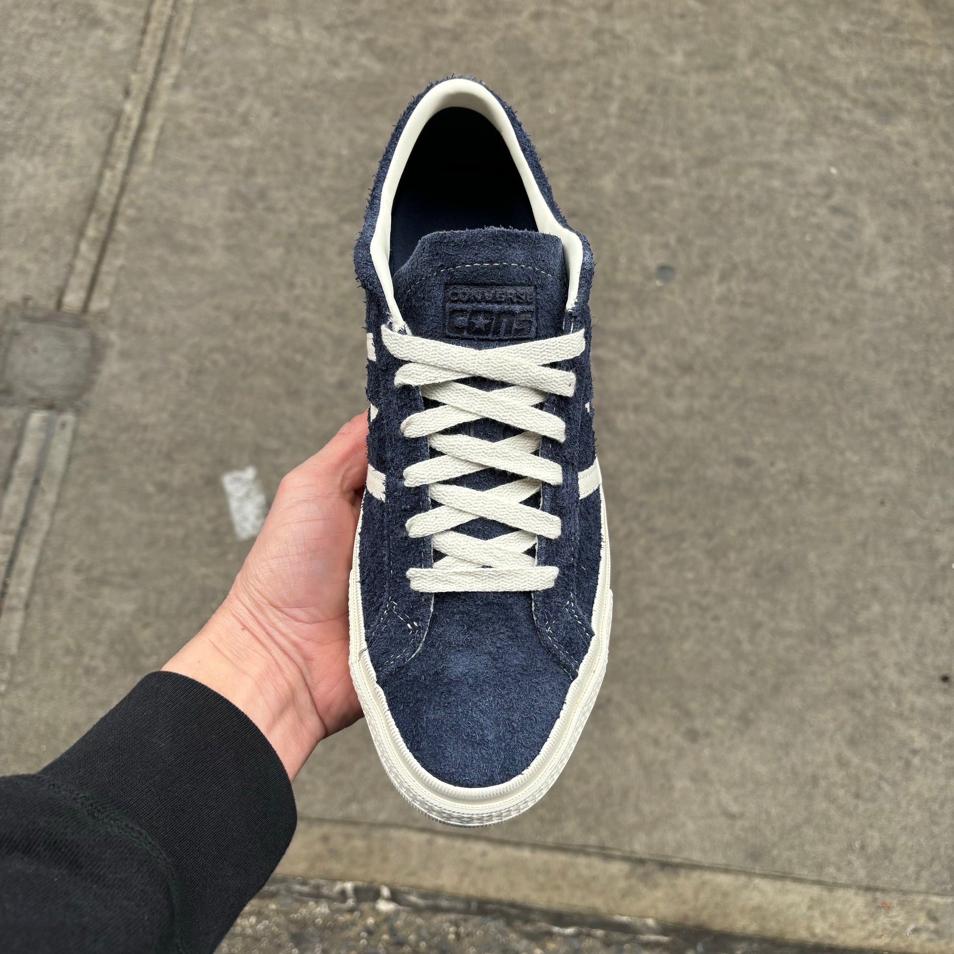 Top down view of navy blue suede skateboard sneaker