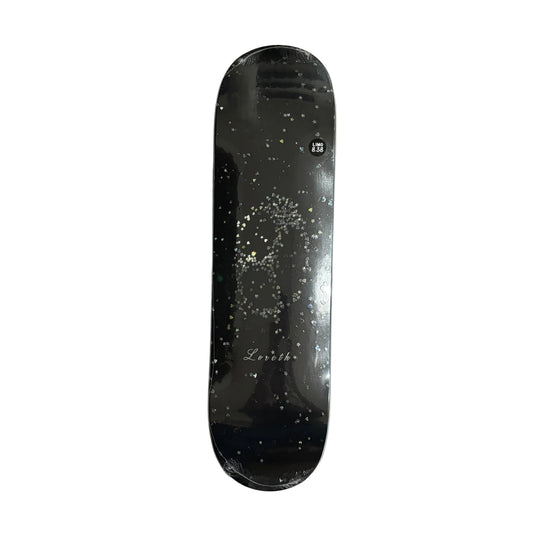 A black skateboard deck with a glittery gold and silver skull graphic and 'Loreth' on the board, on a white background