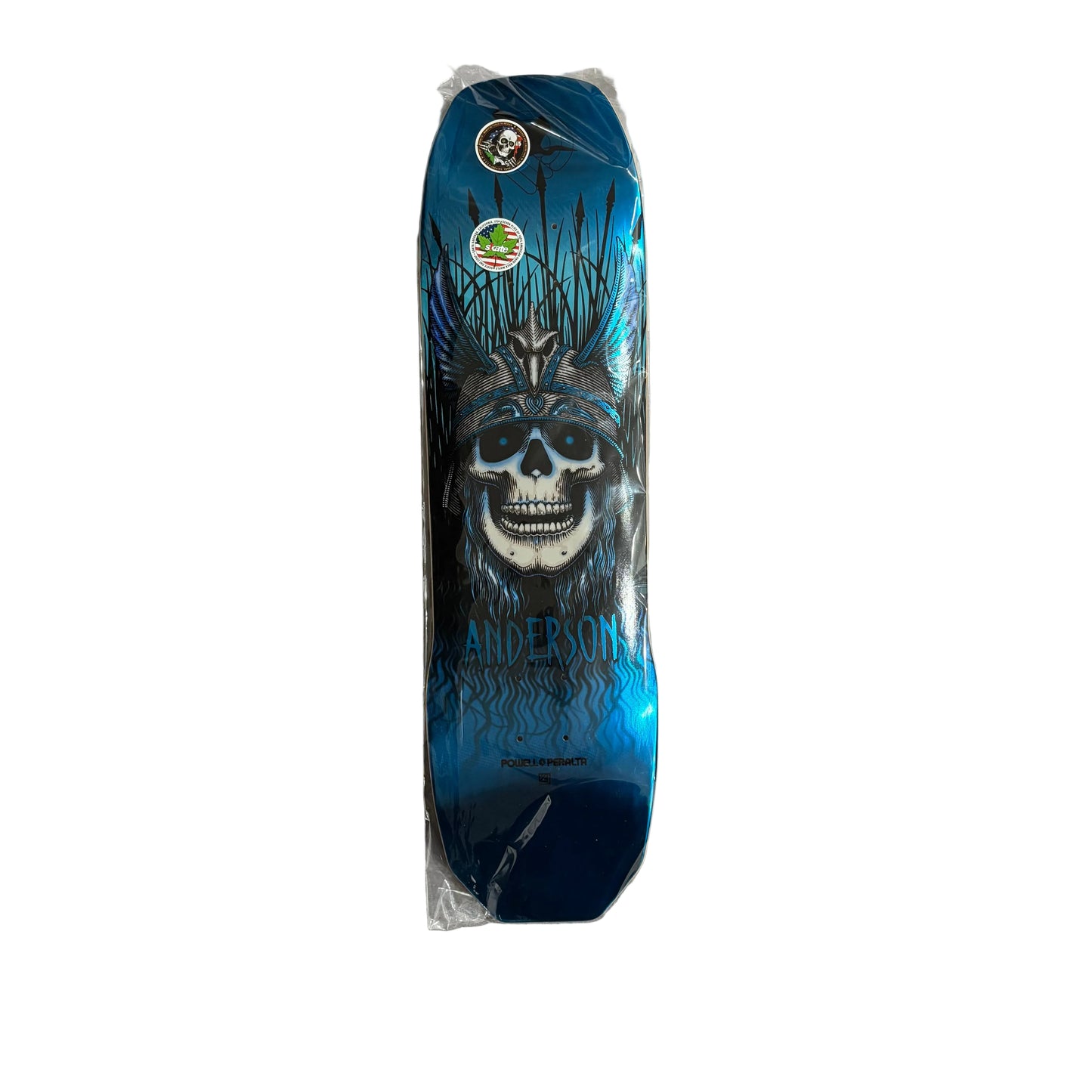 A skateboard deck, featuring a blue and black graphic design of a skull wearing a crown, with the name 'Anderson' printed below. On a white background