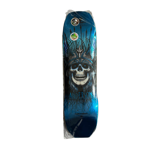 A skateboard deck, featuring a blue and black graphic design of a skull wearing a crown, with the name 'Anderson' printed below. On a white background