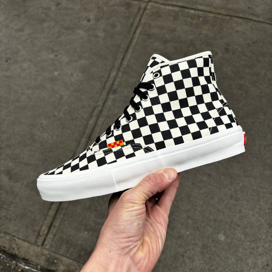 side view of canvas checkboard mid top skateboard sneaker