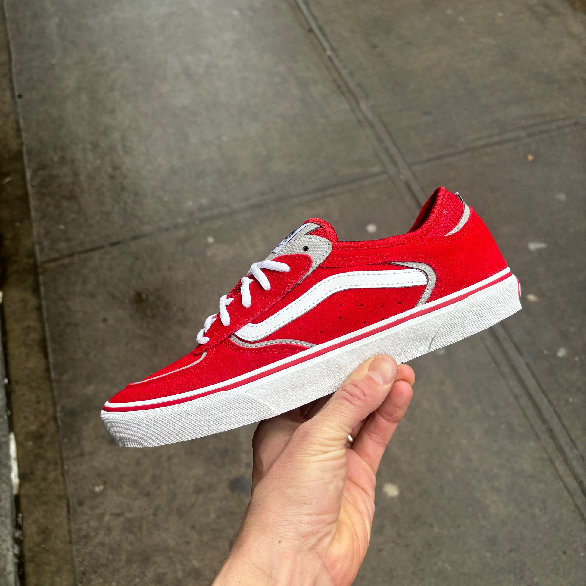 side view of red suede lowtop sneaker