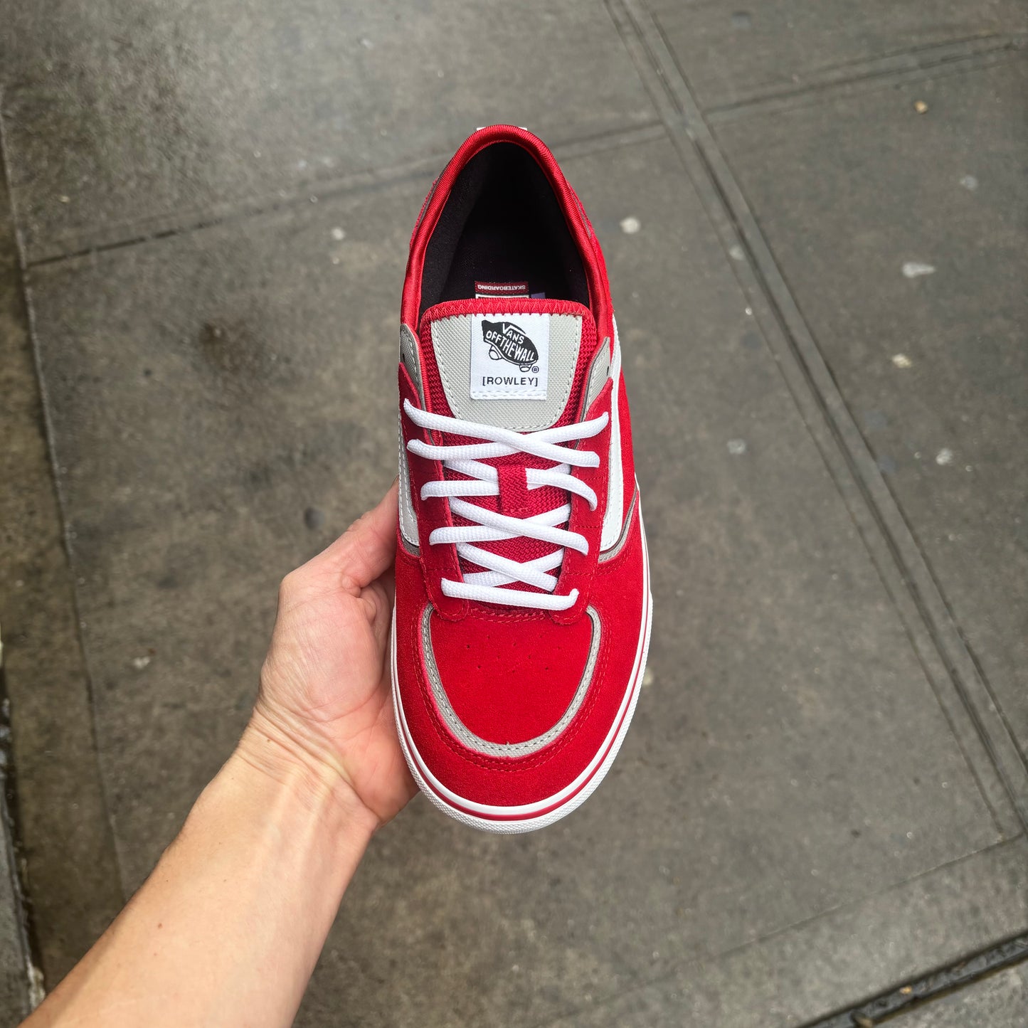 top down view of red suede lowtop sneaker