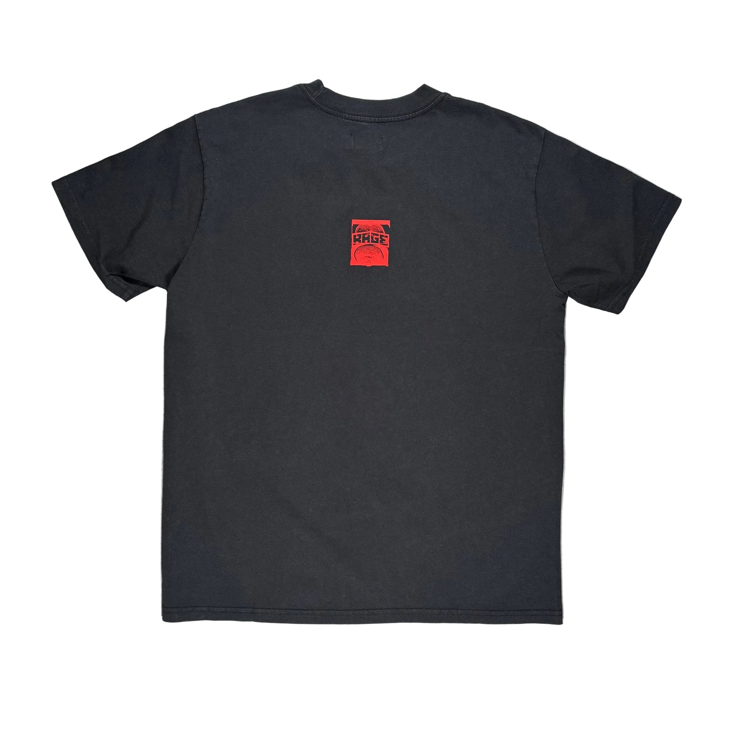 The back side of a black short-sleeve t-shirt laid flat on a white surface, featuring a small red square graphic on the upper left chest with the text 'RAGE'.