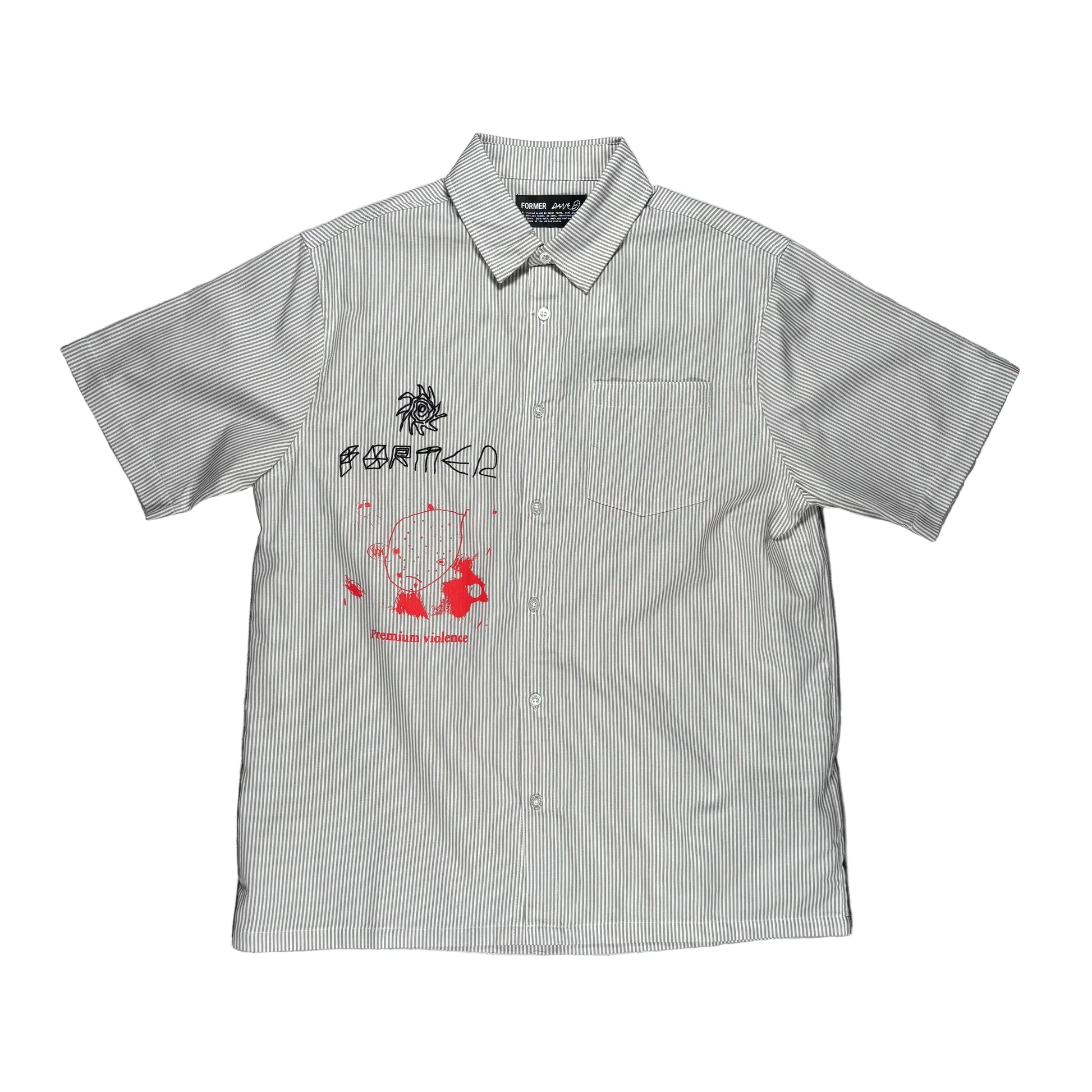 A short-sleeve button-up shirt laid flat on a textured gray surface. The shirt has a very fine vertical stripe pattern in off-white and a muted green-gray, featuring a red and black graphic print on the left chest with the text former premium violence