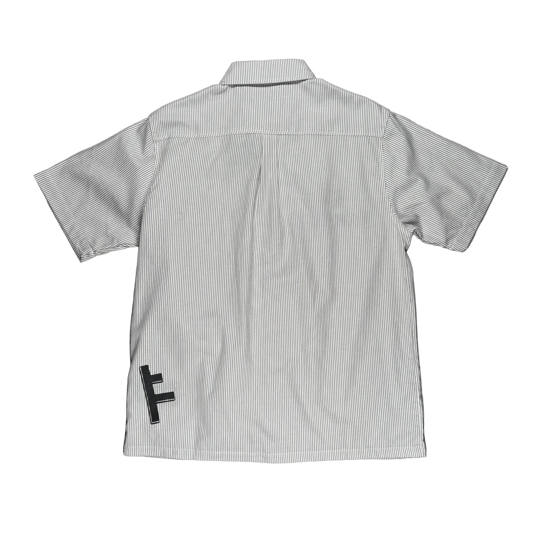 A light gray and white vertically striped short-sleeve button-up shirt shown from the back, laid flat on a white surface with A black screen print with a stylized letter 'F' is visible near the lower left back.