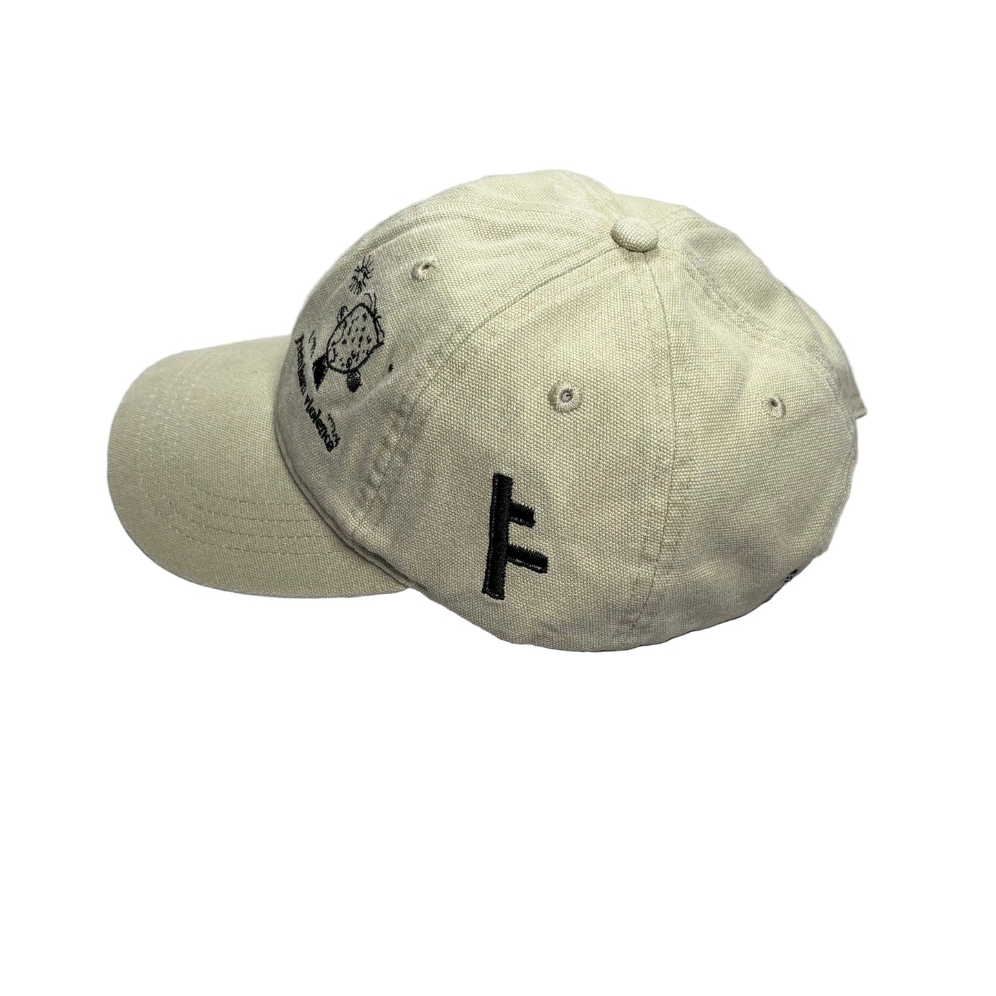 A light beige baseball cap with black embroidered graphics, including a large letter 'F' on the side and a small graphic on the front, resting on a white surface.