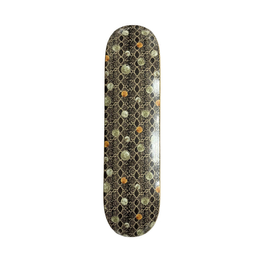 A skateboard deck with a dark brown and black honeycomb pattern with coins, and colorful circular spots in orange, green, and white, resting on a white background