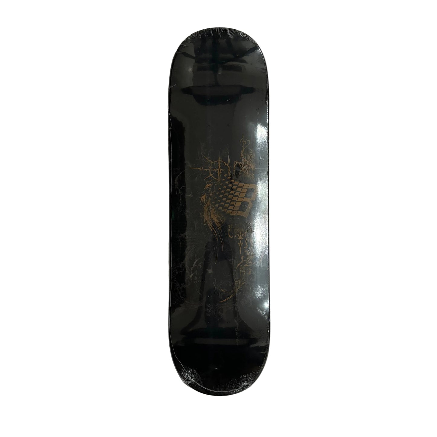 A black skateboard deck with a gold graphic design, shown flat on a white surface