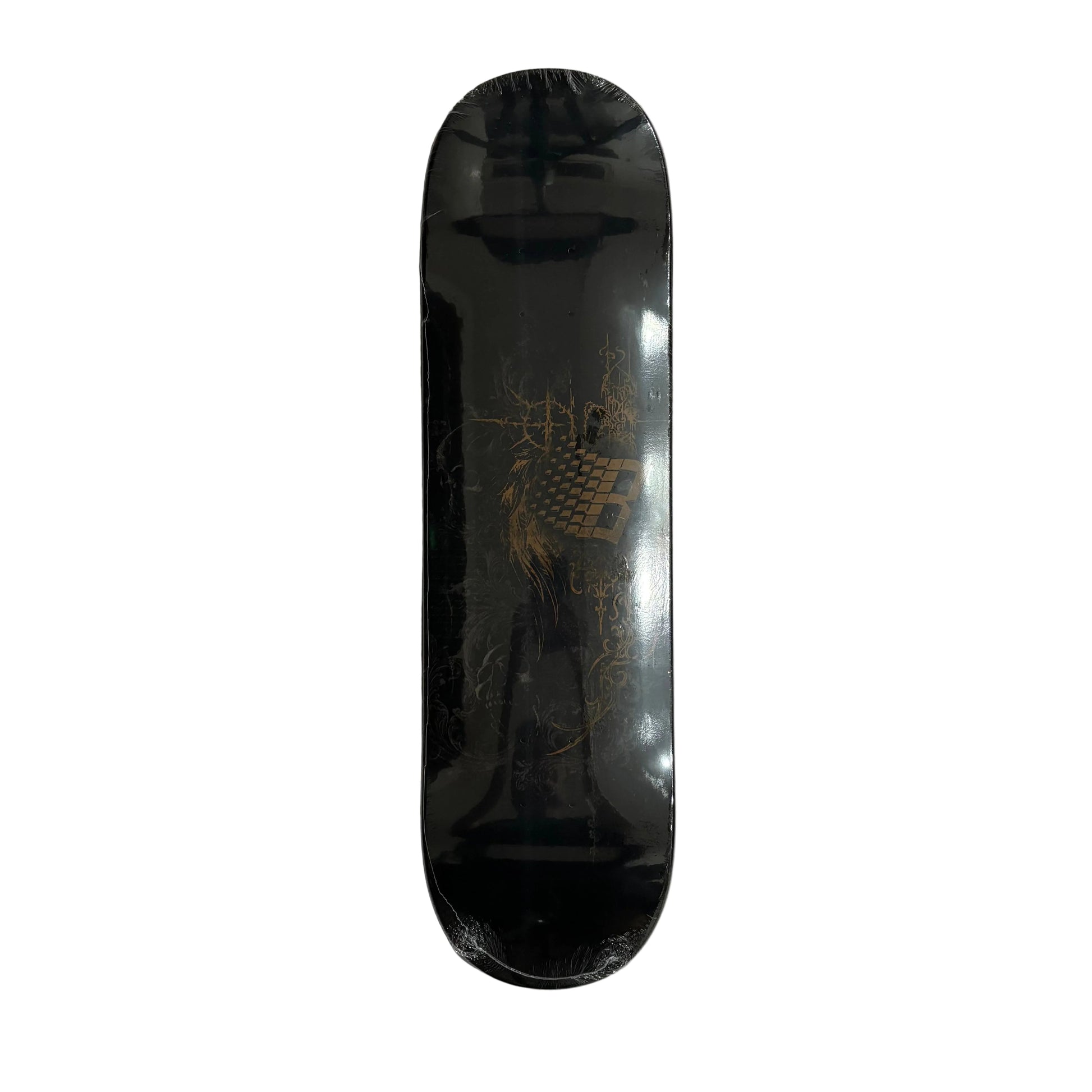 A black skateboard deck with a gold graphic design, shown flat on a white surface