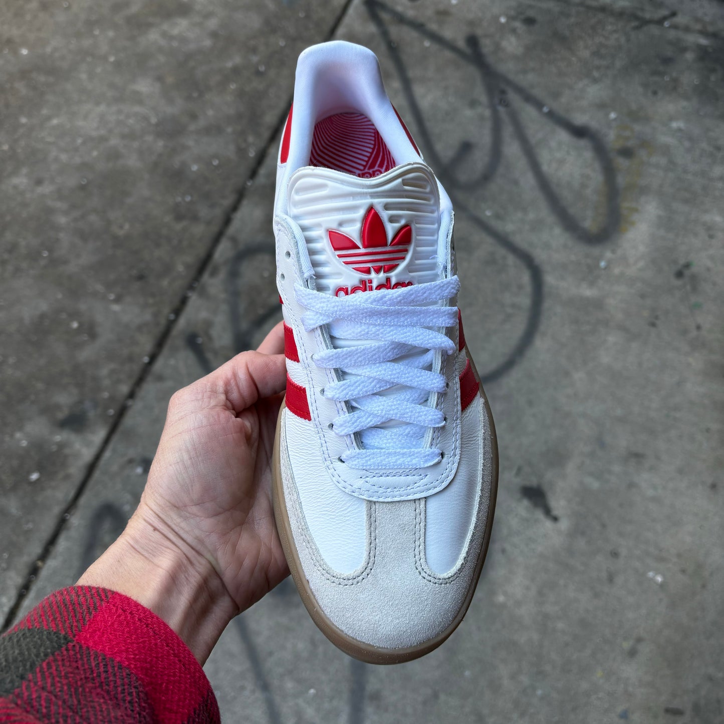 top down view of white and red suede and leather lowtop skateboard sneaker