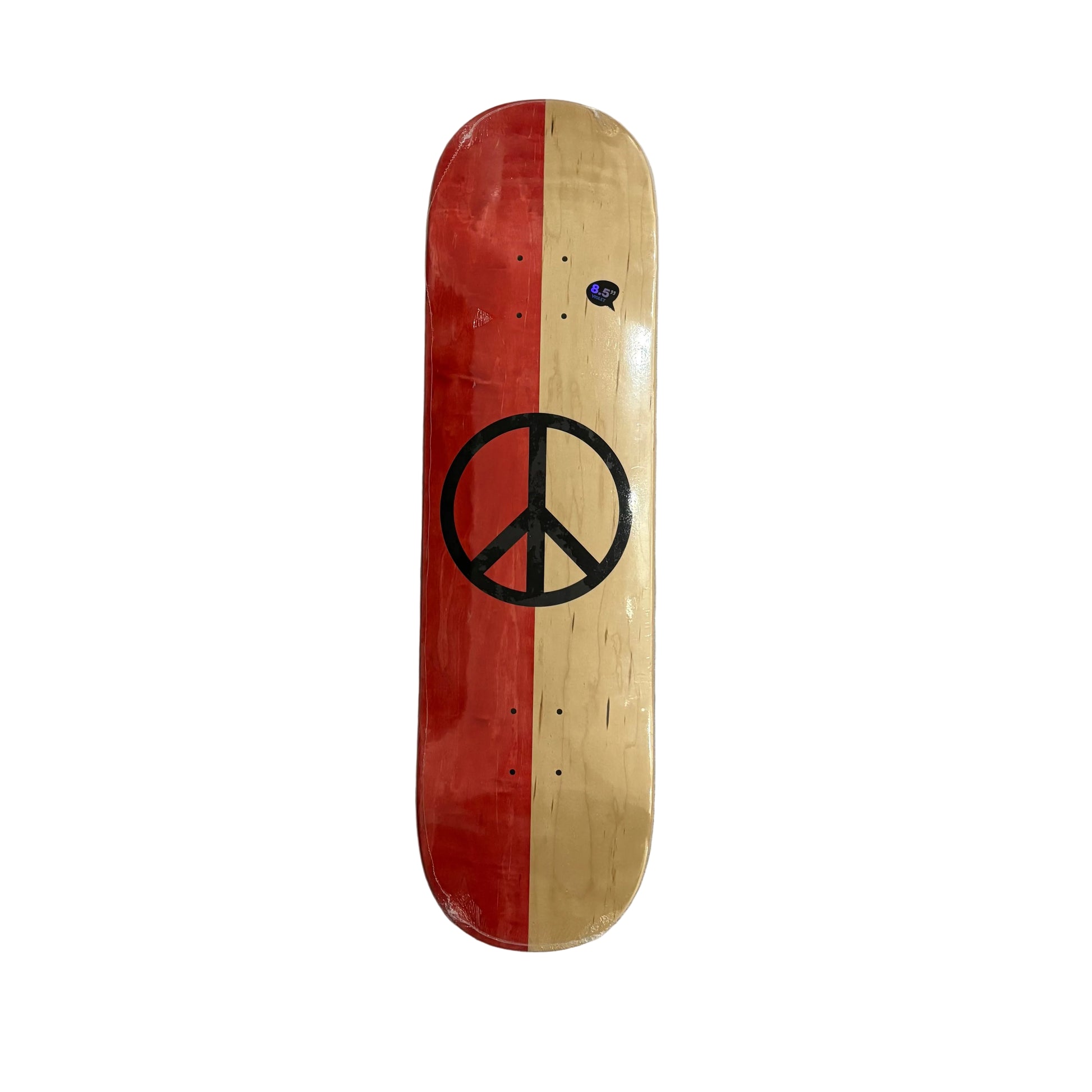 A skateboard deck with a split red and natural wood design, featuring a large black peace sign graphic in the center, photographed from above on a white surface.