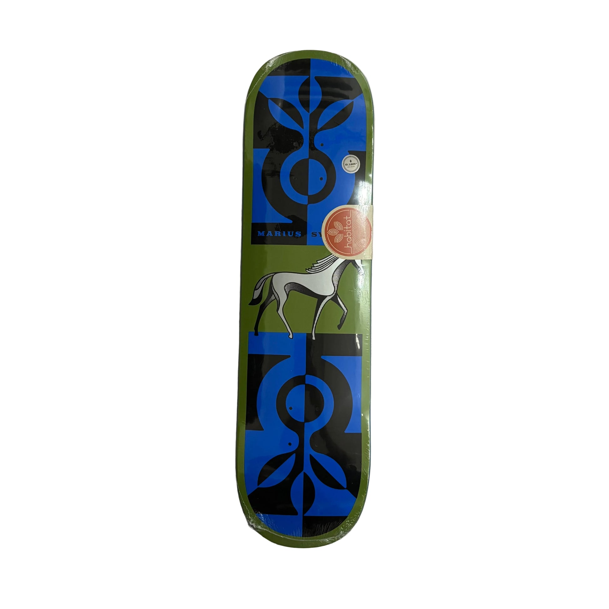A skateboard deck in its clear plastic shrink wrap, featuring a green, black, and blue graphic design with a stylized horse and circular logos, photographed flat on a white surface.