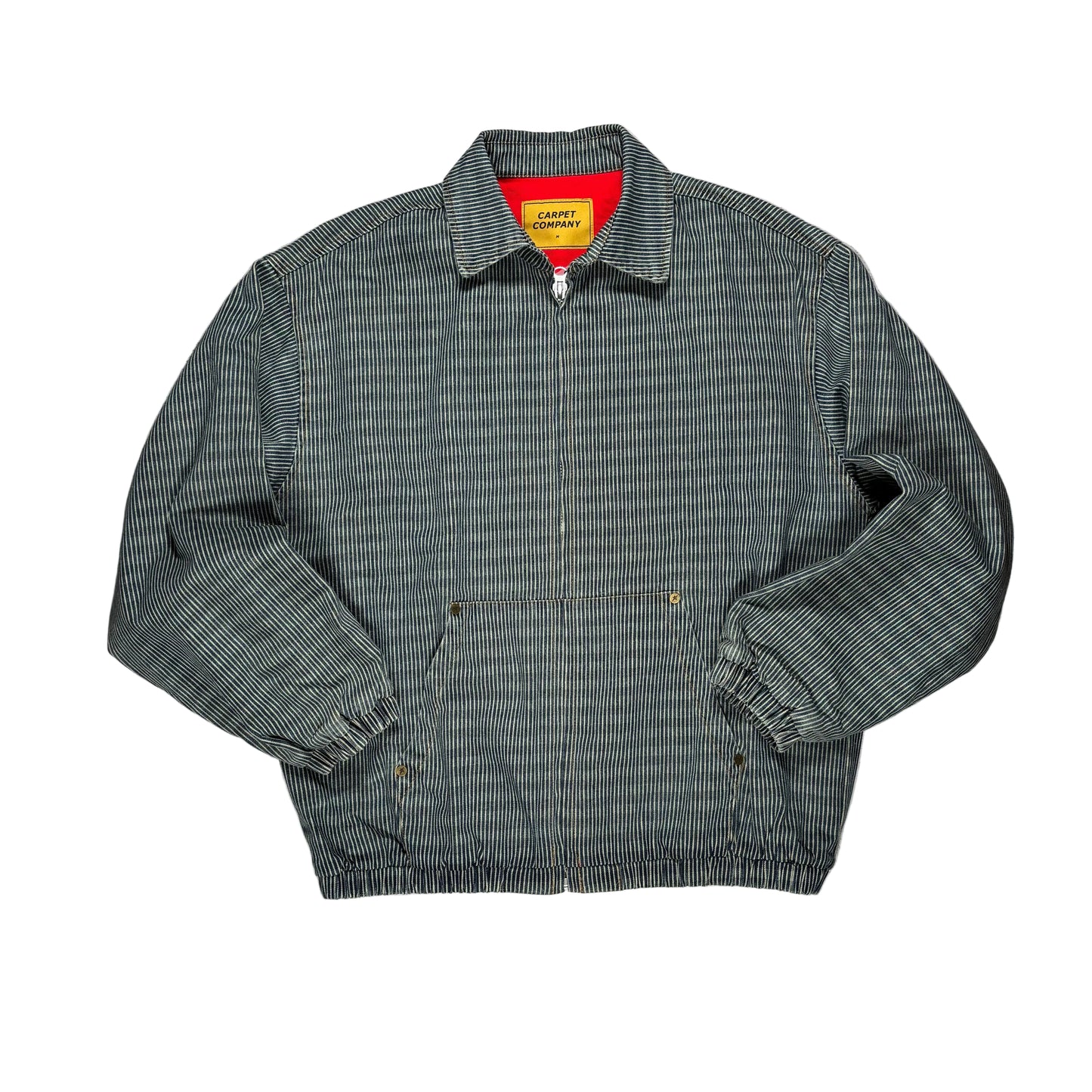 A vintage-style work jacket with a fine gray and white striped pattern, featuring a zippered front, elasticized cuffs and hem, and a bright red inner collar lining with a yellow 'CARPET COMPANY' brand label.