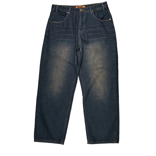 Dark wash blue denim jeans laid flat on a white surface.