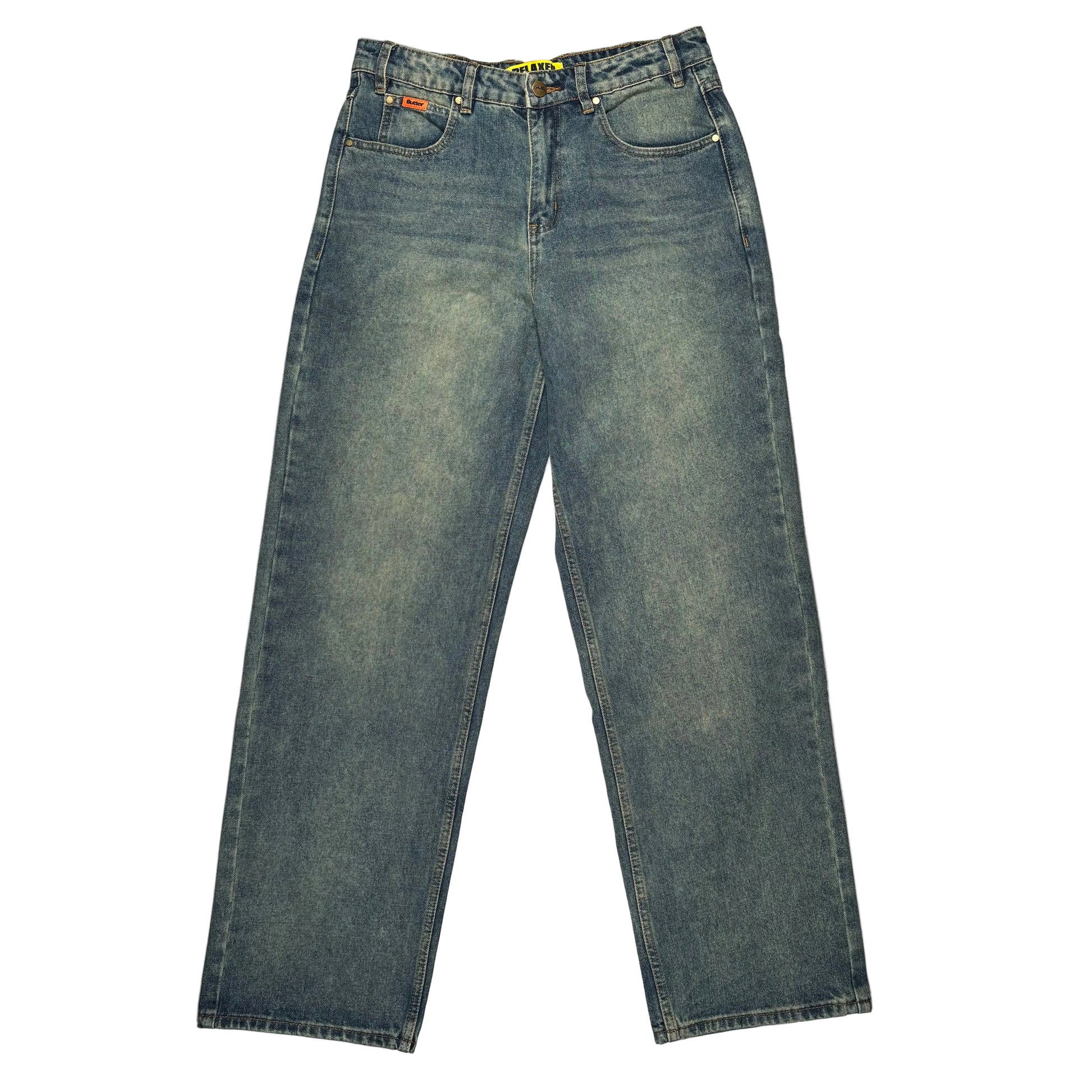 A pair of faded blue denim jeans laid flat on a white surface.