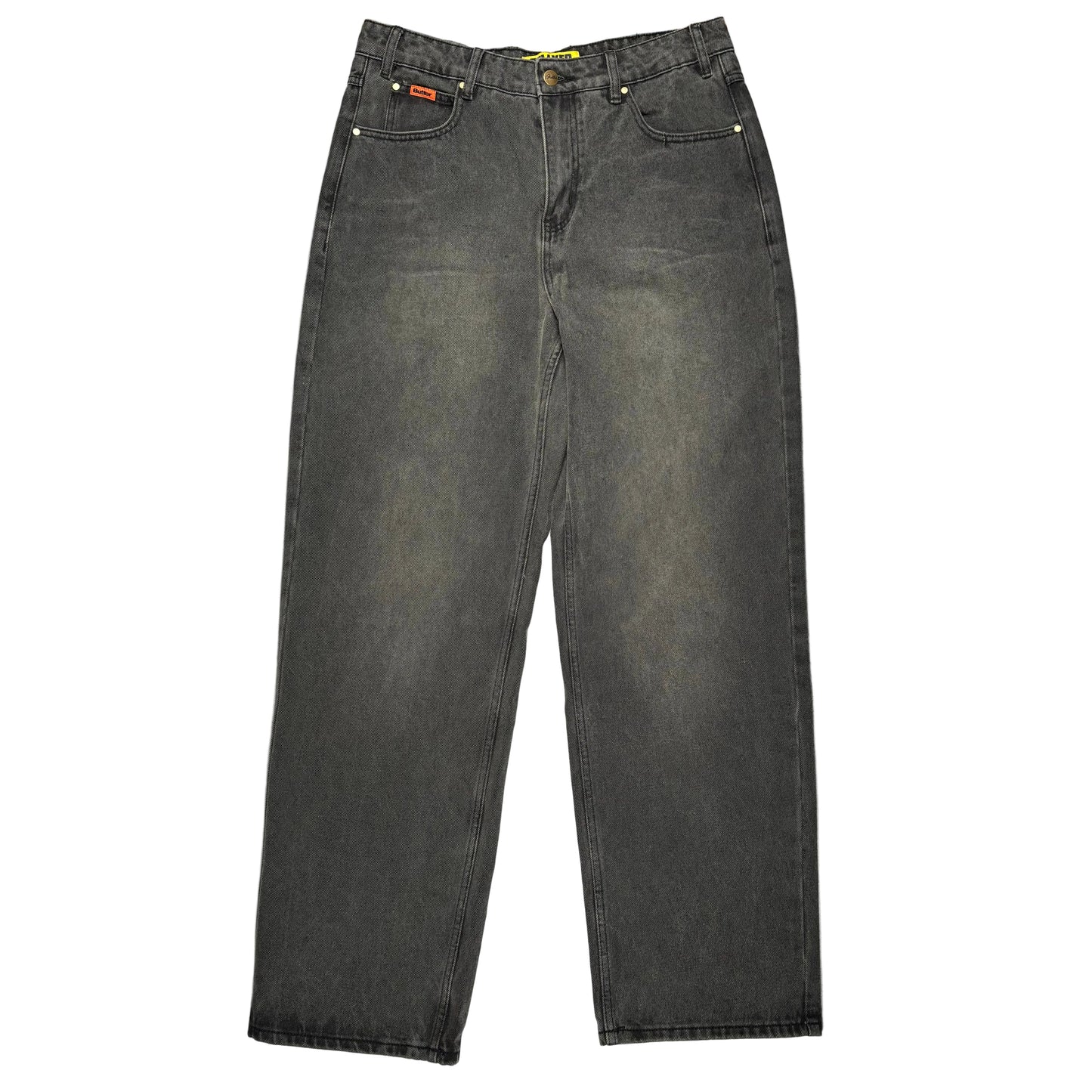 A pair of faded black denim jeans laid flat on a white surface.