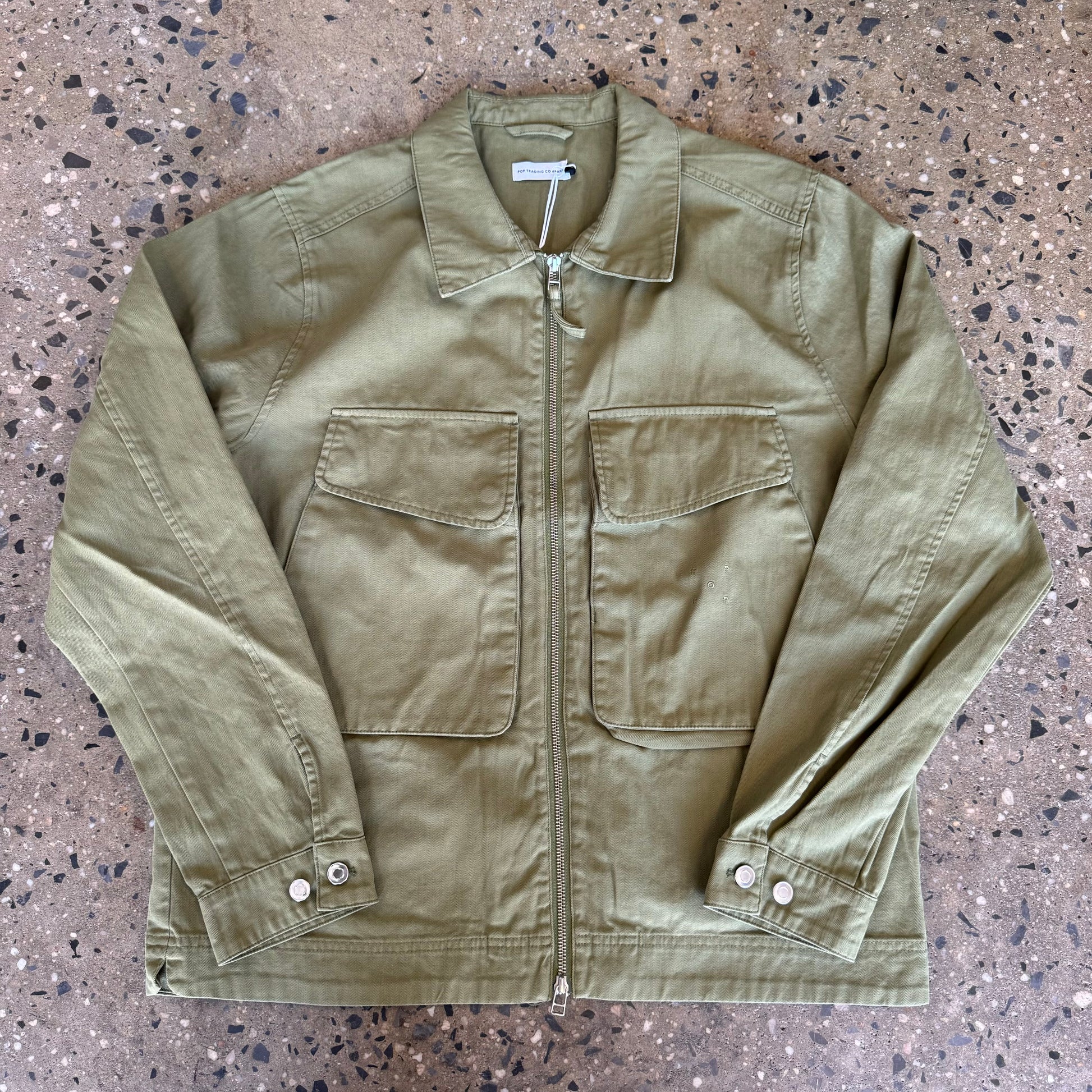 army green jacket with two big pockets in the front and a zipper