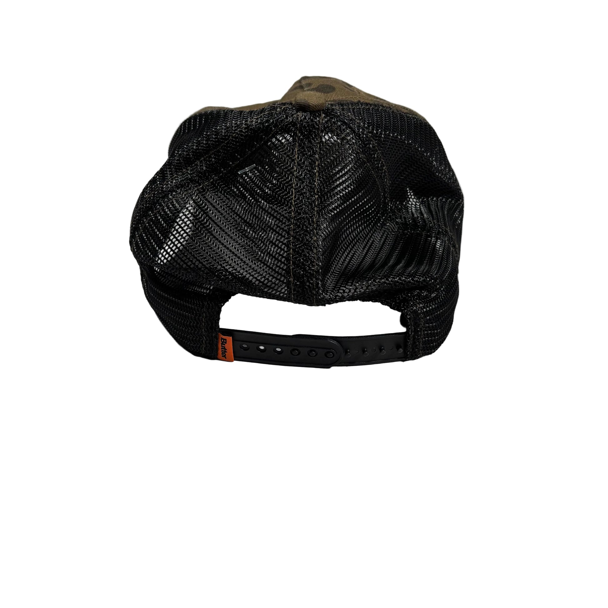 A black mesh-back trucker cap viewed from the back, featuring a brown fabric crown panel and a black adjustable snapback strap with an orange brand tab. Photographed on a white surface.
