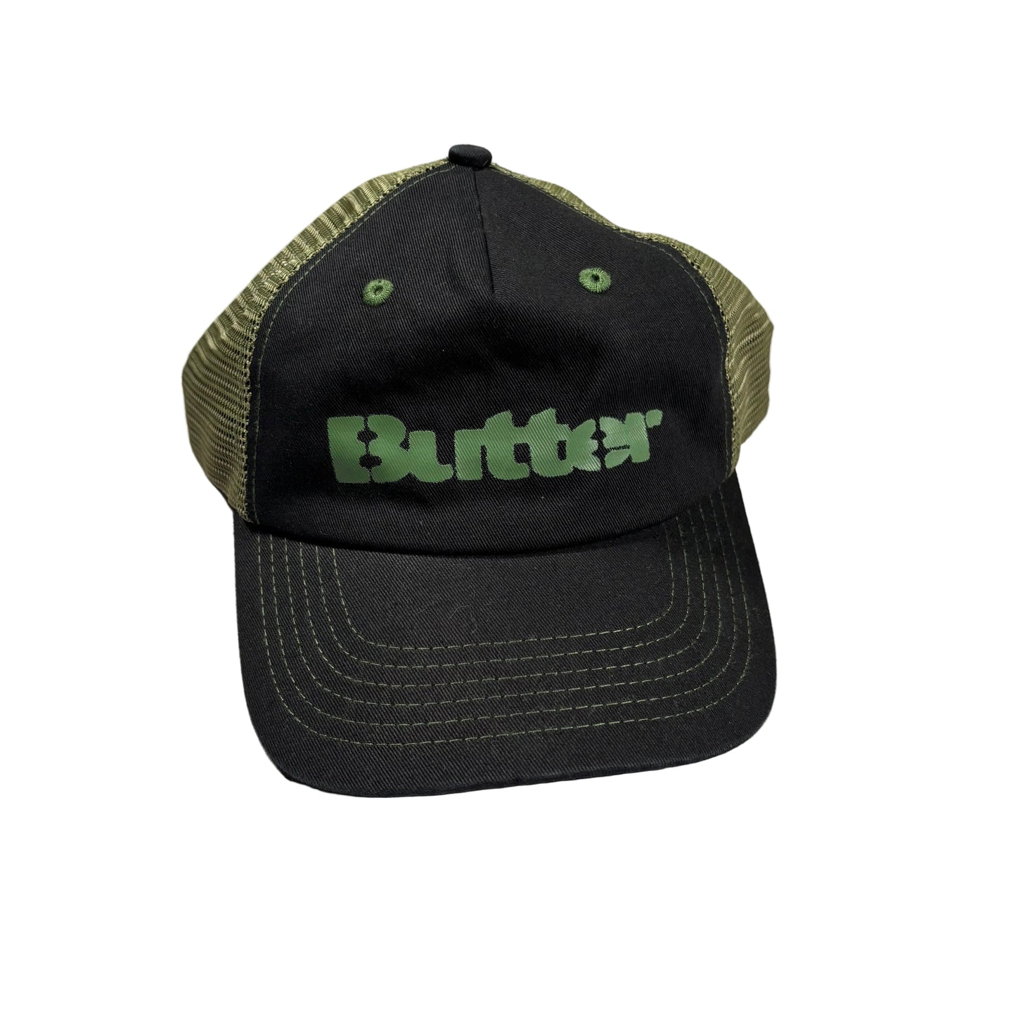 A black trucker hat with olive green mesh back panels and a green 'Butter' logo on the front, resting on a white surface.