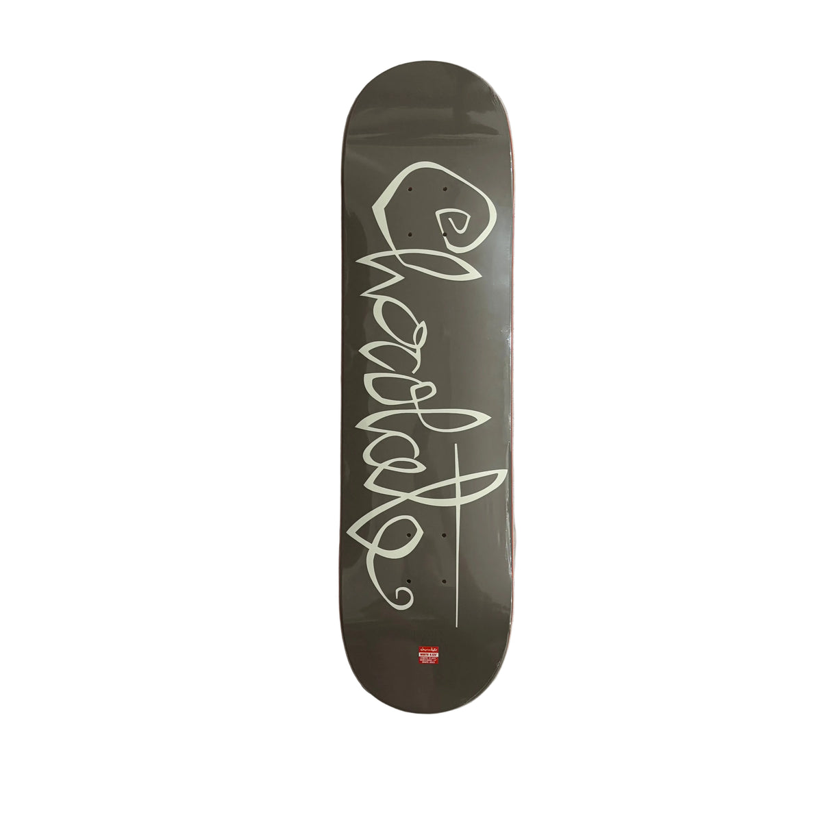 A dark brown skateboard deck with a white stylized Chocolate script graphic and a small red logo near the bottom, photographed from above against a white background.