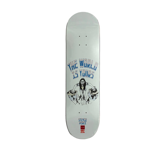 A Stevie Perez skateboard deck with a white base, featuring a blue and black graphic of a man with the text 'THE WORLD IS YOURS' and a red logo at the bottom, displayed flat on a white surface.