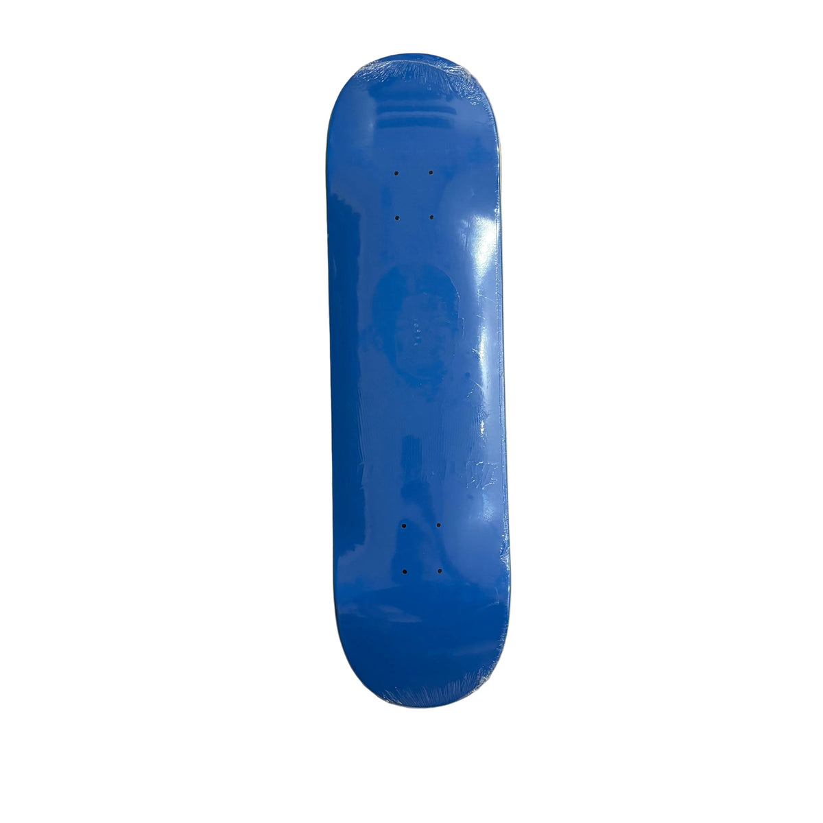 A blue skateboard deck , still in its protective plastic wrapping, displayed vertically on a white surface.